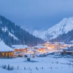 Hotel and Restaurant from Yurt nomadic house complex at Ski resort Shymbulak in Almaty, Kazakhstan. Winter frozen morning blue hour outdoor tourism concept.