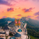 Scenic panoramic view of castles and French village ba na hills at sunset in Da Nang, landmark of Vietnam.